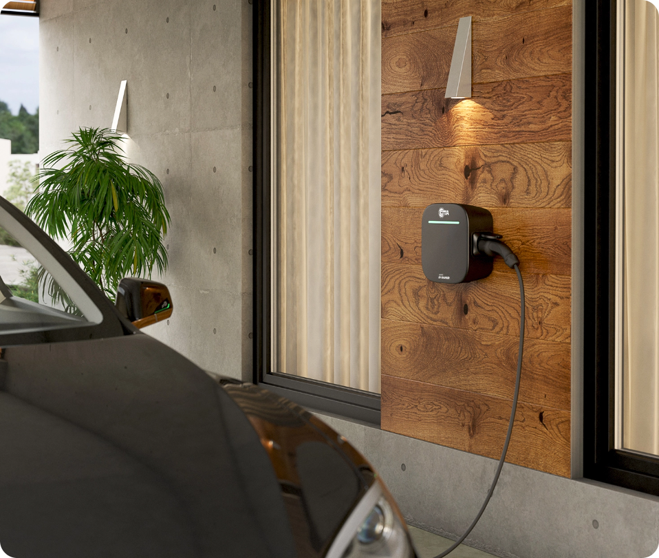 A CITA EV Charger is wall-mounted in a modern garage, with a car parked nearby.