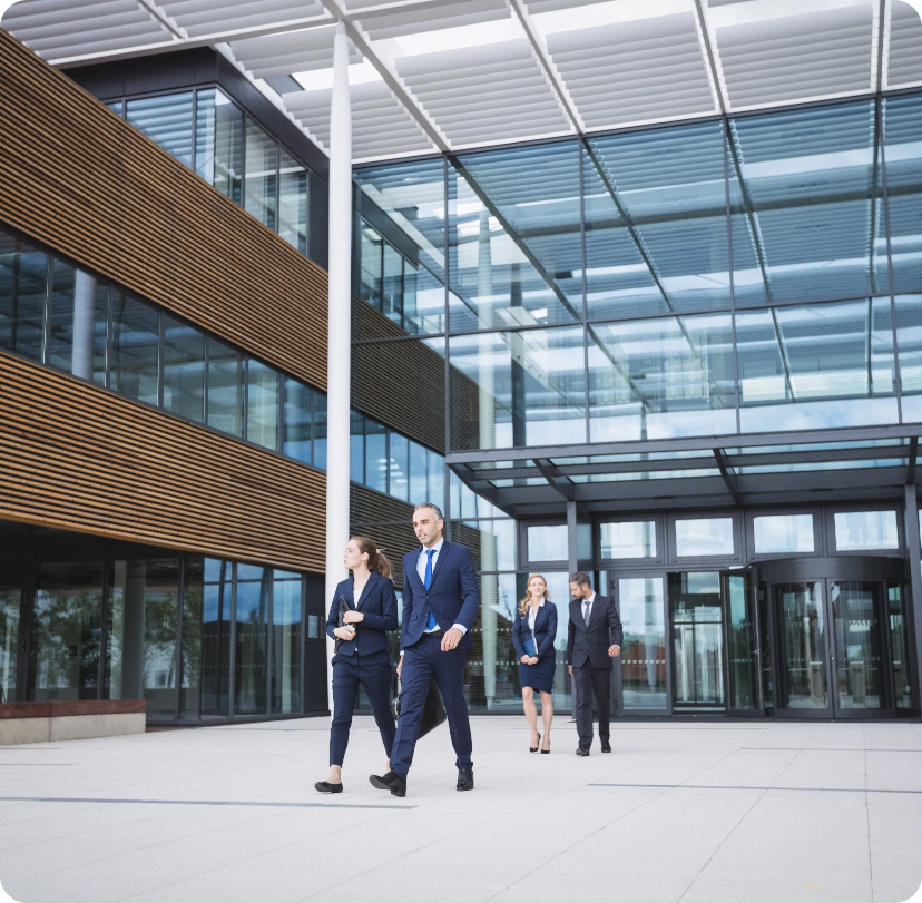 business people walking outside office building